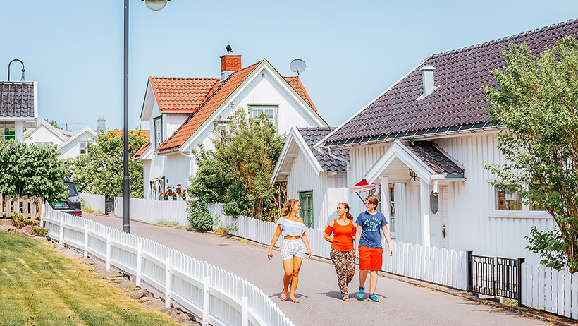 three people walking in a street