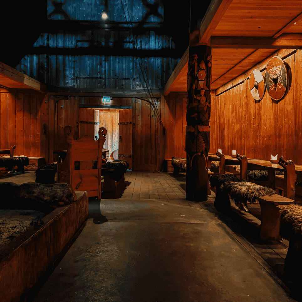 A three-aisled longhouse with shields on the walls, benches with fur covers and a hearth in the central aisle.