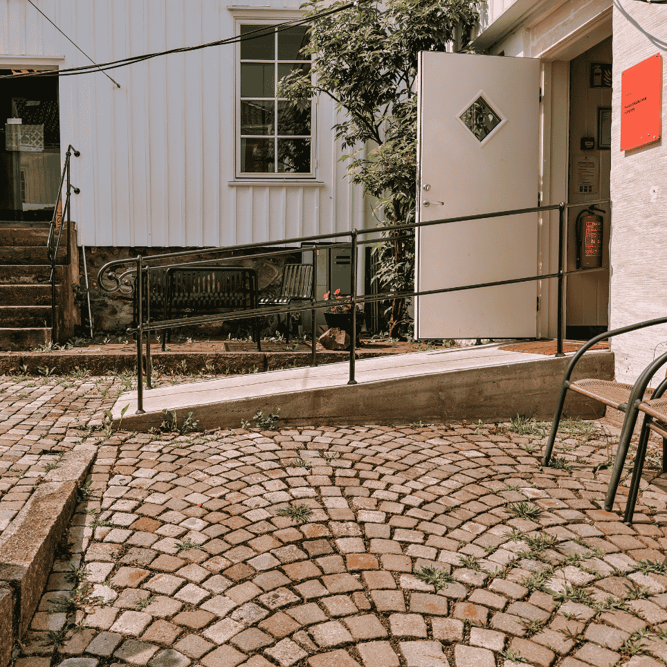 ramp leading into a white building from the cobblestones